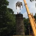 Restored timber frame being lifted back onto the tower